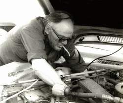 Guy working under the hood of a car