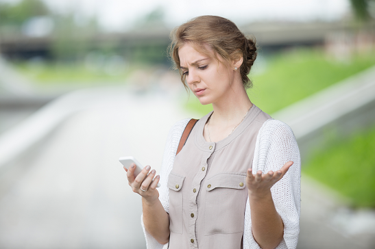 iStock-541588098_resized_frustrated girl looking at phone.png