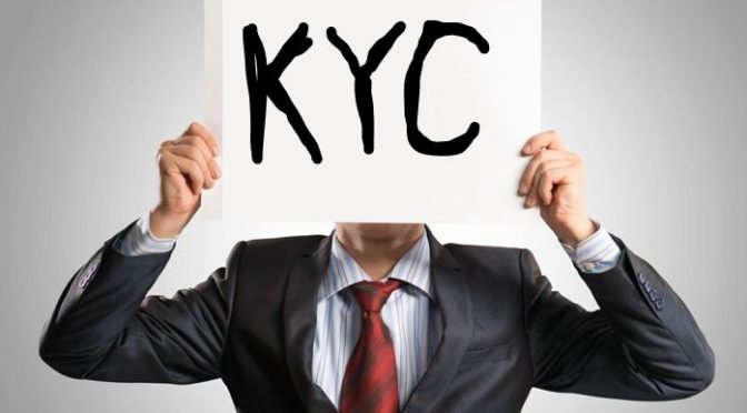 Man holding KYC sign