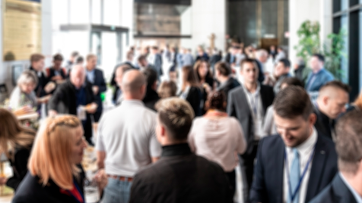 business people at a networking event, slightly out of focus